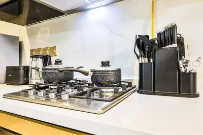 a kitchen counter with two pots on a stove at Dubai Studio Retreat Pool, Gym, Balcony & Queen Bed for Two in Dubai