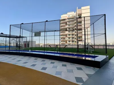 a batting cage in front of a building at Dubai Studio Retreat Pool, Gym, Balcony & Queen Bed for Two in Dubai
