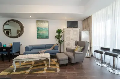 a living room with a couch and chairs and a table at Luxury Living in Matrix Tower Near Sports City in Dubai