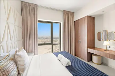 a bedroom with a large bed and a large window at FIRST CLASS 2BR Sun, Views & Serenity in Dubai