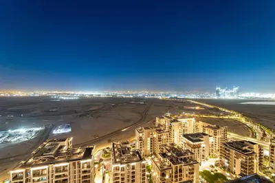 an aerial view of a beach and buildings at night at FIRST CLASS 2BR Sun, Views & Serenity in Dubai