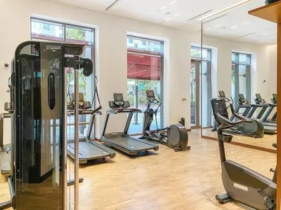 a gym with several treadmills and elliptical machines at FIRST CLASS 2BR Sun, Views & Serenity in Dubai