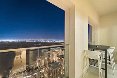 a view from the balcony of a building with a table and chairs at FIRST CLASS 2BR Sun, Views & Serenity in Dubai