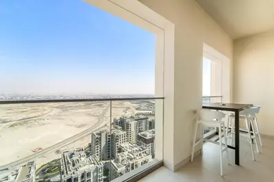 a room with a table and a view of a city at FIRST CLASS 2BR Sun, Views & Serenity in Dubai