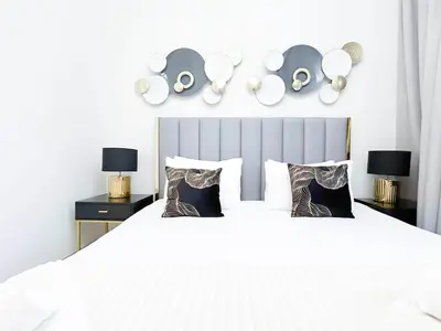 a bedroom with a large white bed with two night stands at Luxurious 2BR in Burj Crown with Burj Khalifa View in Dubai