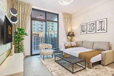a living room with a couch and a table at Designer Apartments in Kensington Waters, MBR City, with Pool Gym Sauna & Parking near Downtown and Creek in Dubai