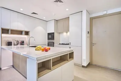 a kitchen with a counter with fruit on it at Designer Apartments in Kensington Waters, MBR City, with Pool Gym Sauna & Parking near Downtown and Creek in Dubai