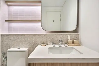 a bathroom with a white sink and a mirror at Designer Apartments in Kensington Waters, MBR City, with Pool Gym Sauna & Parking near Downtown and Creek in Dubai
