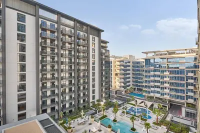 an aerial view of a large apartment building with a pool at Designer Apartments in Kensington Waters, MBR City, with Pool Gym Sauna & Parking near Downtown and Creek in Dubai