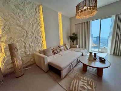 a living room with a couch and a table at Top floor Grande 2BR Luxe Panoramic Sea View BohemianStyle in Dubai