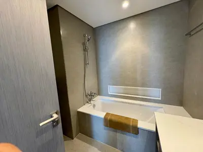 a bathroom with a bath tub with a shower at Top floor Grande 2BR Luxe Panoramic Sea View BohemianStyle in Dubai