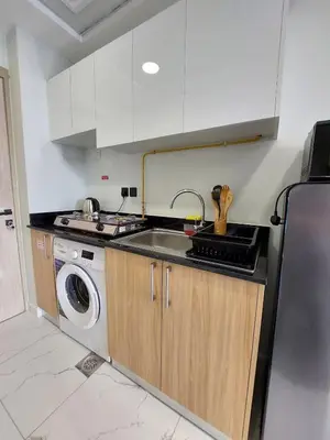 a kitchen with a sink and a washing machine at Urban Studio - Walk to Metro - Homeyvillas in Dubai