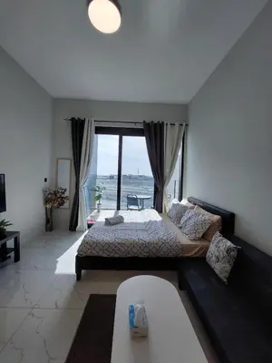 a bedroom with a bed and a large window at Urban Studio - Walk to Metro - Homeyvillas in Dubai