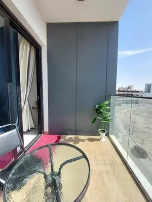 a room with a glass table and a large window at Urban Studio - Walk to Metro - Homeyvillas in Dubai