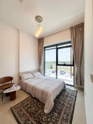 a bedroom with a bed and a large window at COZY 1 BR Apartment in Dubai