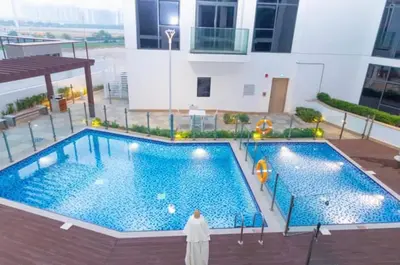 a large swimming pool in the middle of a building at COZY 1 BR Apartment in Dubai