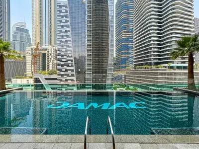 a swimming pool in a city with tall buildings at Near Dubai Mall Downtown Views Infinity Pool in Dubai