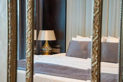 a reflection of a bed in a mirror at Near Dubai Mall Downtown Views Infinity Pool in Dubai