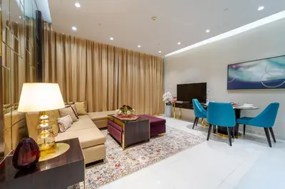 a living room with a couch and a table at Near Dubai Mall Downtown Views Infinity Pool in Dubai