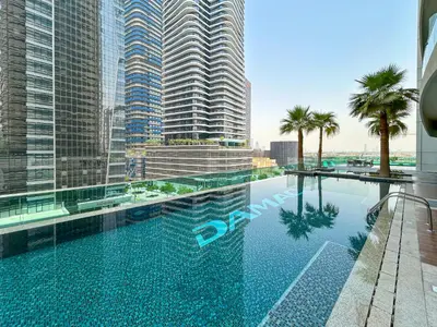 a swimming pool in front of some tall buildings at Near Dubai Mall Downtown Views Infinity Pool in Dubai