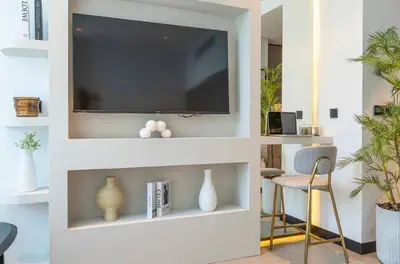 a living room with a flat screen tv on a wall at Gem in the heart of Business Bay - 15 Northside in Dubai