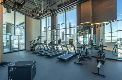 a gym with treadmills and ellipticals in a building at Gem in the heart of Business Bay - 15 Northside in Dubai