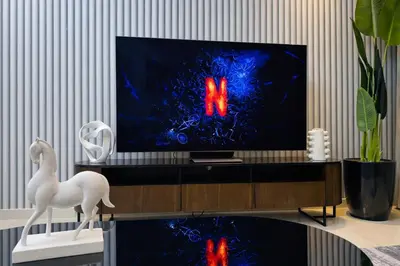 a living room with a tv screen with the letter n on it at 2BR Burj Khalifa and Sea View Apartments in Paramount Hotel Midtown in Dubai