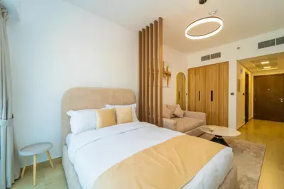 a bedroom with a bed and a couch and a table at Luxurious Serenity 5-Star Lifestyle in JVC in Dubai