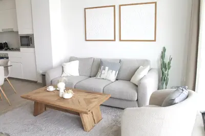 a living room with a couch and a coffee table at Palace Residences luxurious 2 bedroom with breathtaking views in Dubai