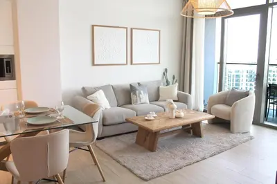 a living room with a couch and a table at Palace Residences luxurious 2 bedroom with breathtaking views in Dubai