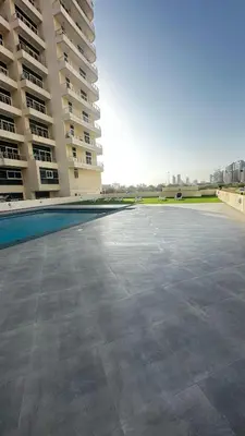 an empty parking lot in front of a building at Tranquil & Elegant Studio in Dubai Sports City in Dubai