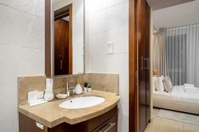 a bathroom with a sink and a mirror at Stylish 1BR Apartment near Burj Khalifa and Dubai Fountain, Downtown in Dubai