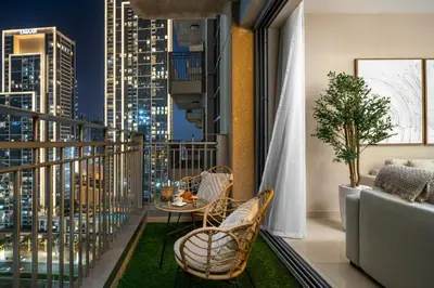 a balcony with a table and chairs and a city skyline at Stylish 1BR Apartment near Burj Khalifa and Dubai Fountain, Downtown in Dubai