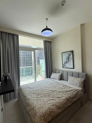 a bedroom with a bed and a large window at Stylish 1-Bedroom Apartment near burj khalifa in Dubai