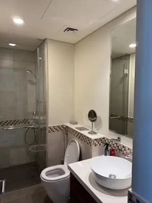 a bathroom with a toilet and a sink and a shower at Stylish 1-Bedroom Apartment near burj khalifa in Dubai