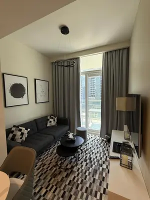 a living room with a couch and a table at Stylish 1-Bedroom Apartment near burj khalifa in Dubai