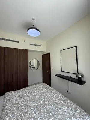 a bedroom with a bed and a flat screen tv at Stylish 1-Bedroom Apartment near burj khalifa in Dubai