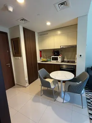 a kitchen with a table and two chairs and a table at Stylish 1-Bedroom Apartment near burj khalifa in Dubai