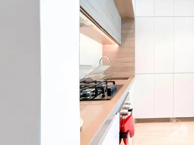 a kitchen with white cabinets and a stove top oven at New! Cozy & Stylish Studio at Studio One Marina in Dubai
