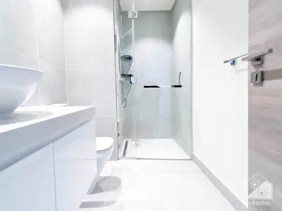 a white bathroom with a shower and a toilet at New! Cozy & Stylish Studio at Studio One Marina in Dubai