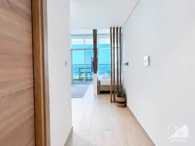 a hallway with a door leading to a bedroom at New! Cozy & Stylish Studio at Studio One Marina in Dubai