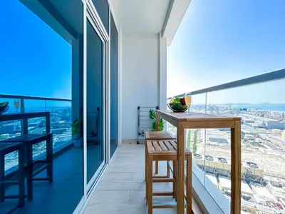 a balcony with a table and a view of the city at New! Cozy & Stylish Studio at Studio One Marina in Dubai