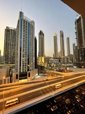 a view of a city with tall buildings and highways at Vogue Downtown Mag 318 near Burj Khalifa and Dubai Mall, Studio Apartment with Balcony, Canal and City View, Access to all Amenities in Sabkhah