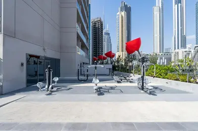 a group of exercise equipment on the side of a building at Vogue Downtown Mag318 near Burj Khalifa and Dubai Mall, Studio Apartment with Balcony, Canal and City View, Access to all Amenities in Sabkhah