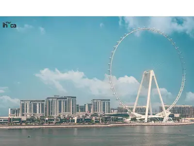 a large ferris wheel in front of a city at Boho Studio Beachfront Ain Sea View JBR Walk 1min in Dubai
