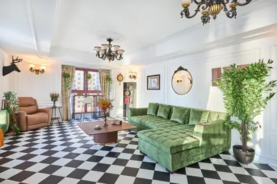 a living room with a green couch and a table at Zen Den - Vintage Charm with full Sea View in Dubai