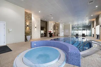a large swimming pool in a hotel room with a large tub at Zen Den - Vintage Charm with full Sea View in Dubai