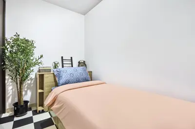 a bedroom with a bed and a black and white checkered floor at Zen Den - Vintage Charm with full Sea View in Dubai