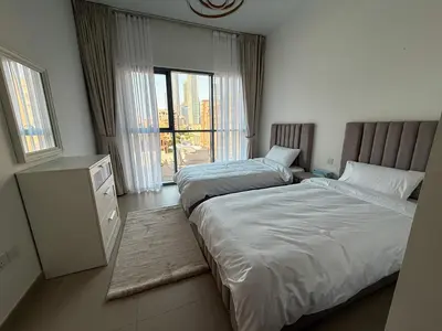 a hotel room with two beds and a window at Luxury 2bdr apartment with Burj views & resort amenities in Dubai