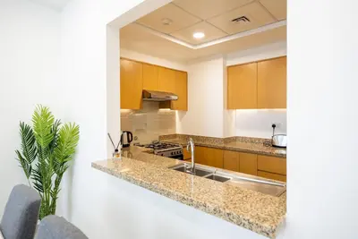 a kitchen with a sink and a counter top at Luxury 2bdr apartment with Burj views & resort amenities in Dubai